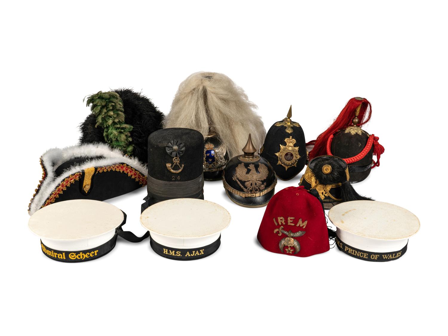 A Collection of Twenty-One Military Parade Helmets, Hats and Masks