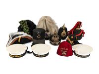 A Collection of Twenty-One Military Parade Helmets, Hats and Masks