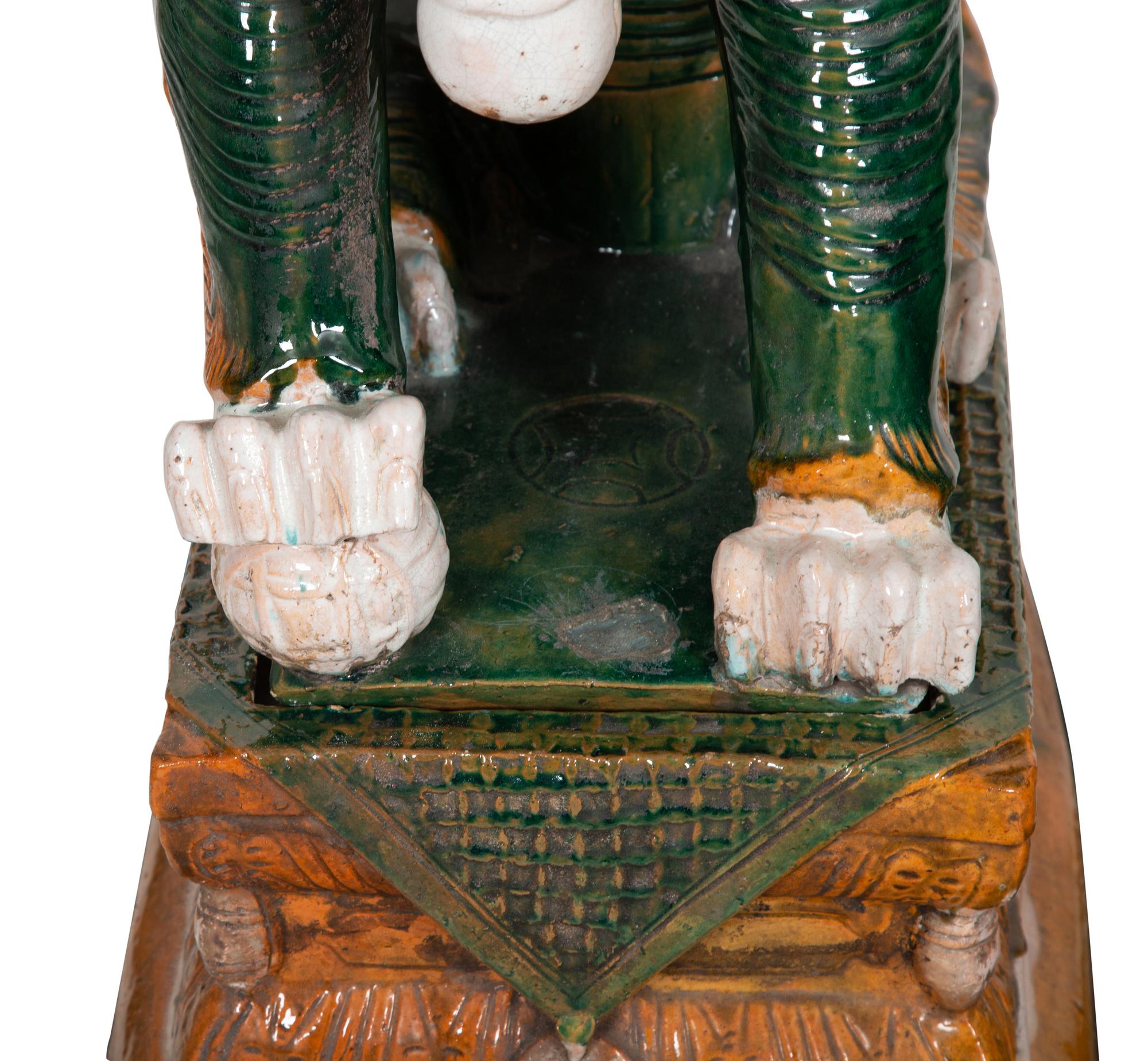 A Pair of Chinese Sançai Glazed Ceramic Guardian Lions on Pedestal Bases