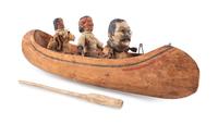 [ROOSEVELT, Theodore (1858-1919)]. Folk art canoe and figures representing Theodore Roosevelt's exploration of the River of Doubt during his expedition to Brazil in 1913-1914.