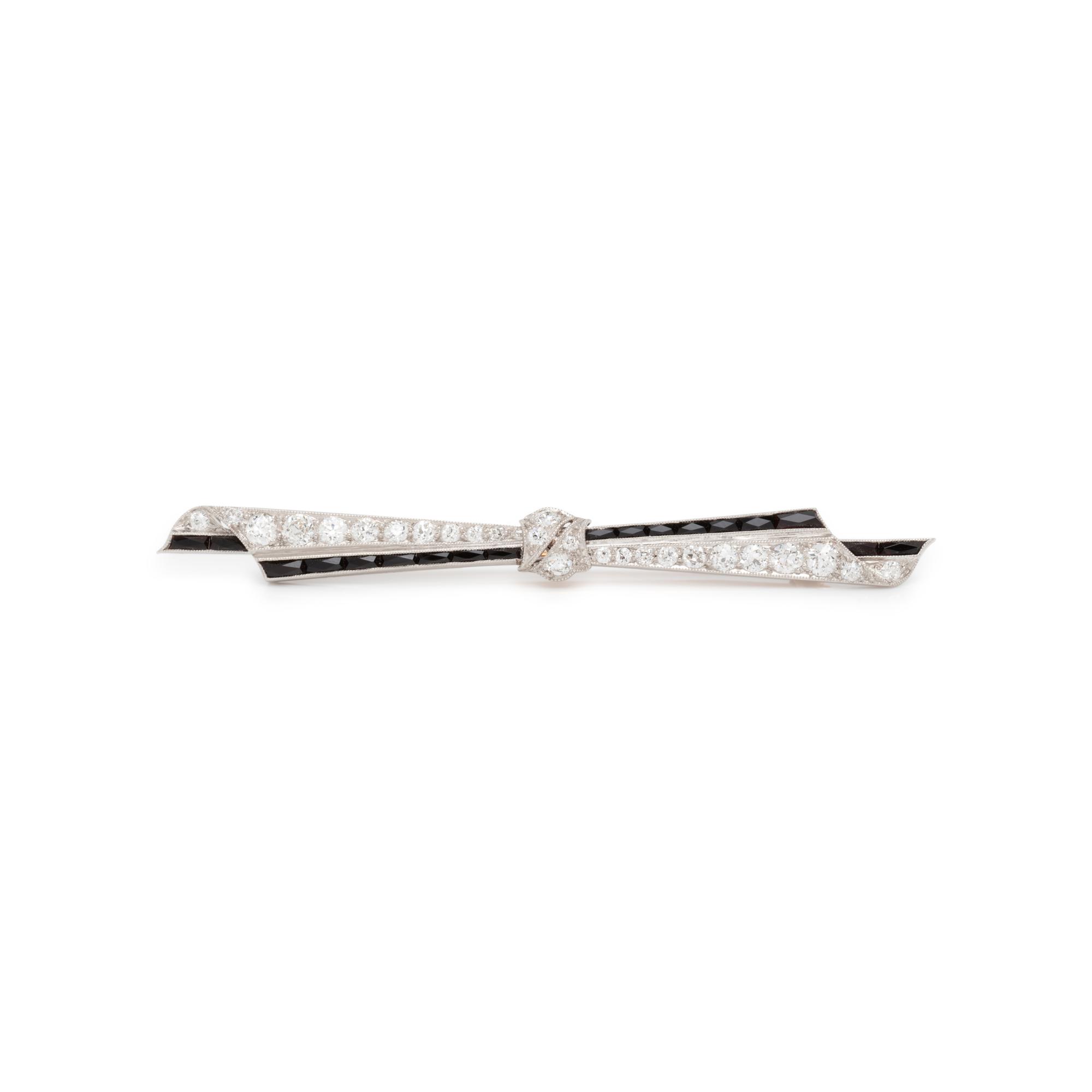 ART DECO, DIAMOND AND ONYX BOW BROOCH