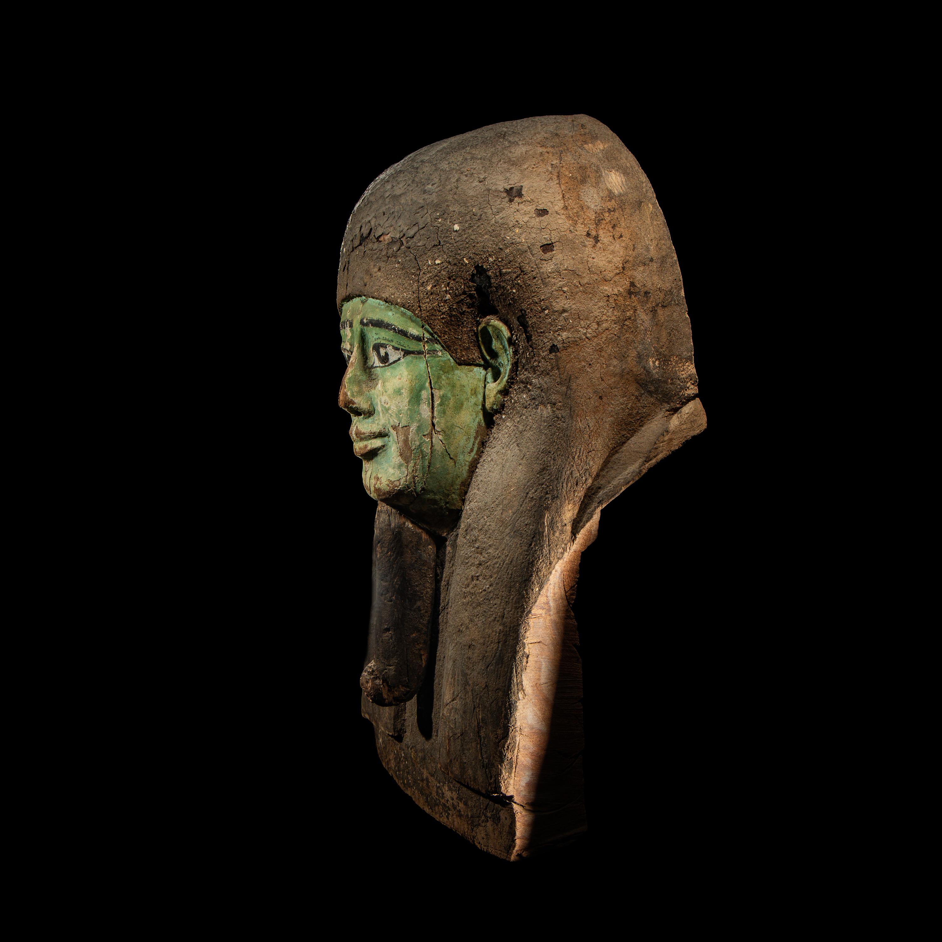 An Egyptian Painted Wood Sarcophagus Head