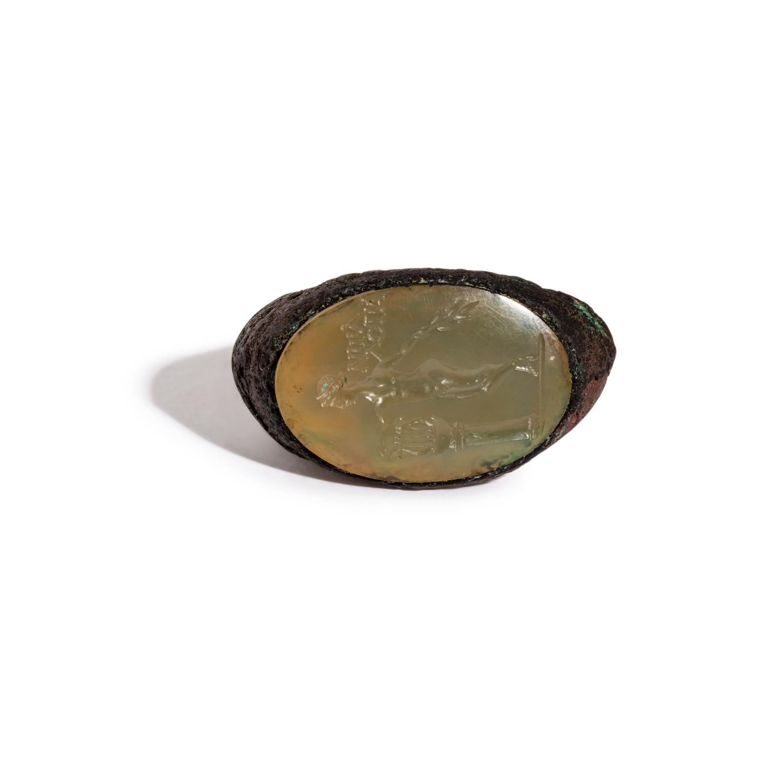 A Roman Copper Alloy and Chalcedony Finger Ring with the God Apollo