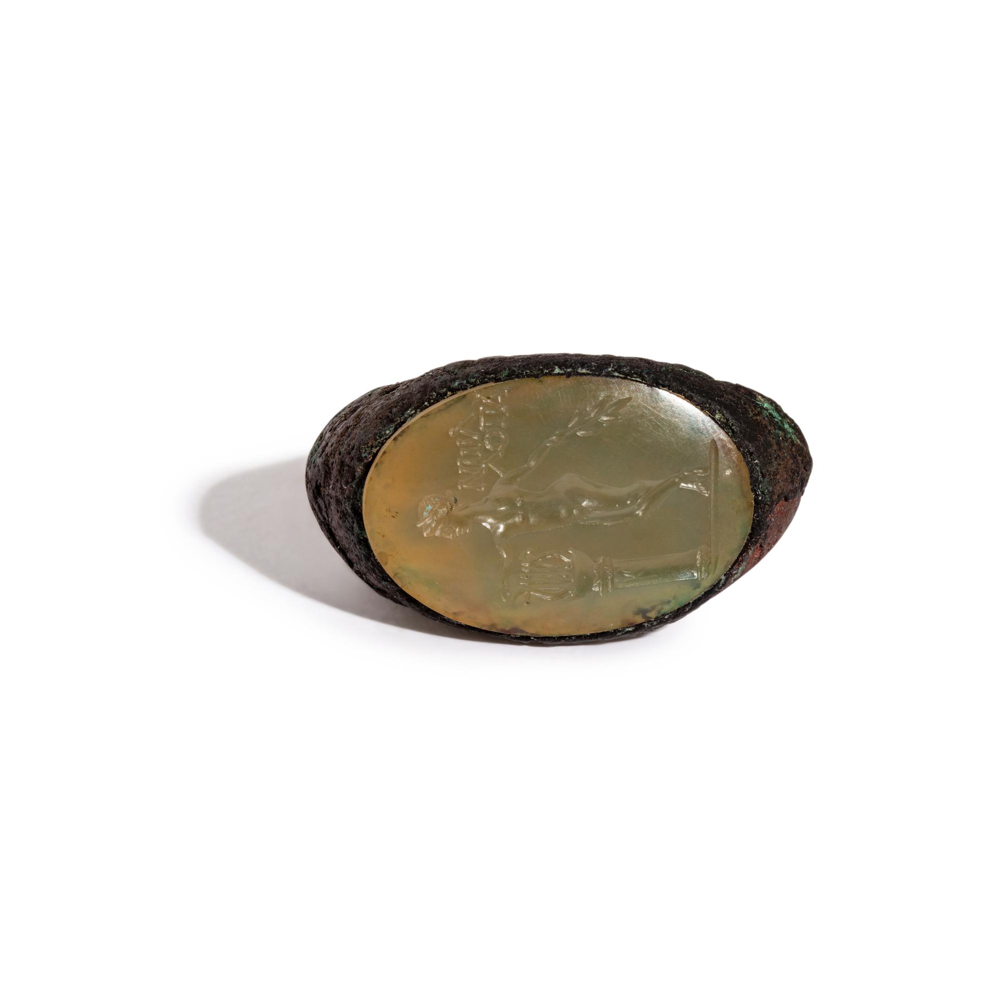 A Roman Copper Alloy and Chalcedony Finger Ring with the God Apollo