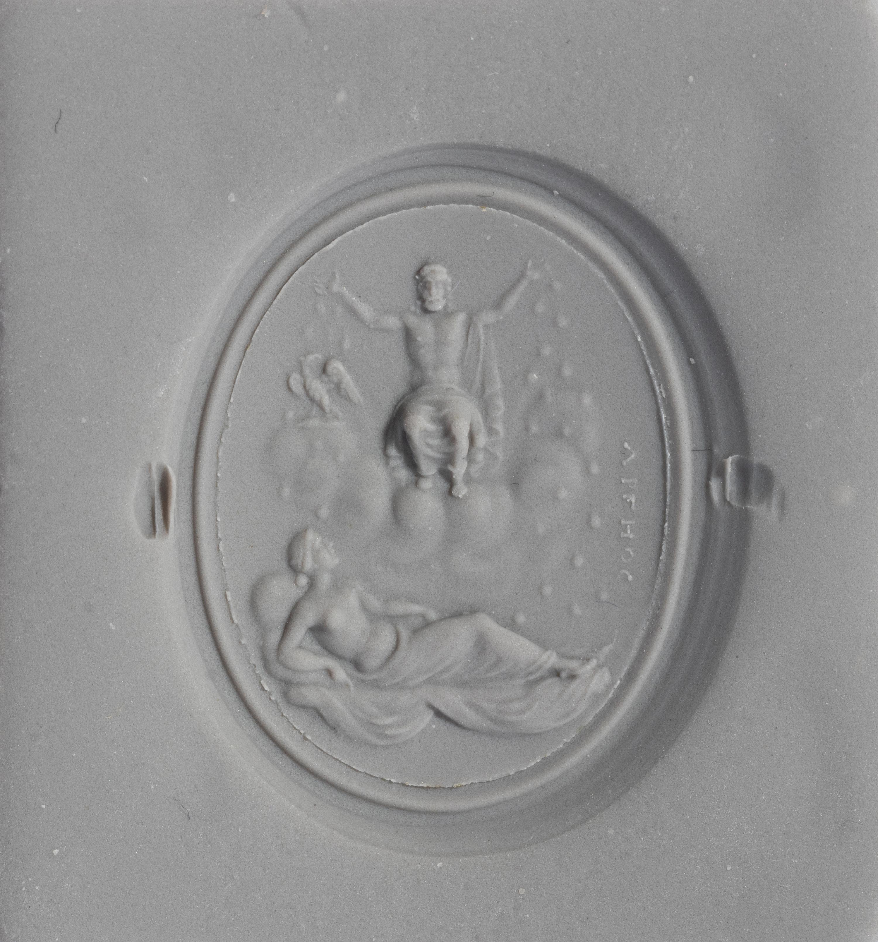 A Neoclassical Gold and Carnelian Finger Ring with the God Zeus, a Reclining Female, and a Greek Inscription