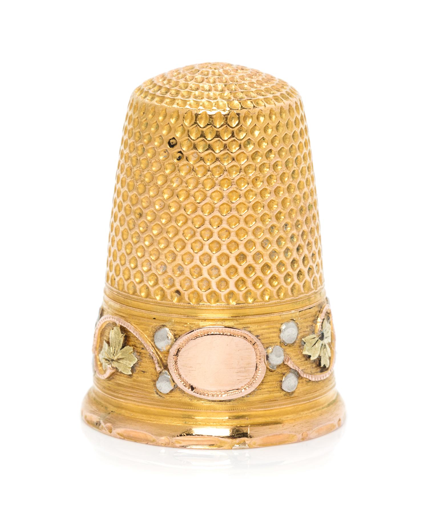 A French Tri-Colored Gold Thimble, , the knurled top and body above a rose, white and yellow gold band worked to show foliate and berry