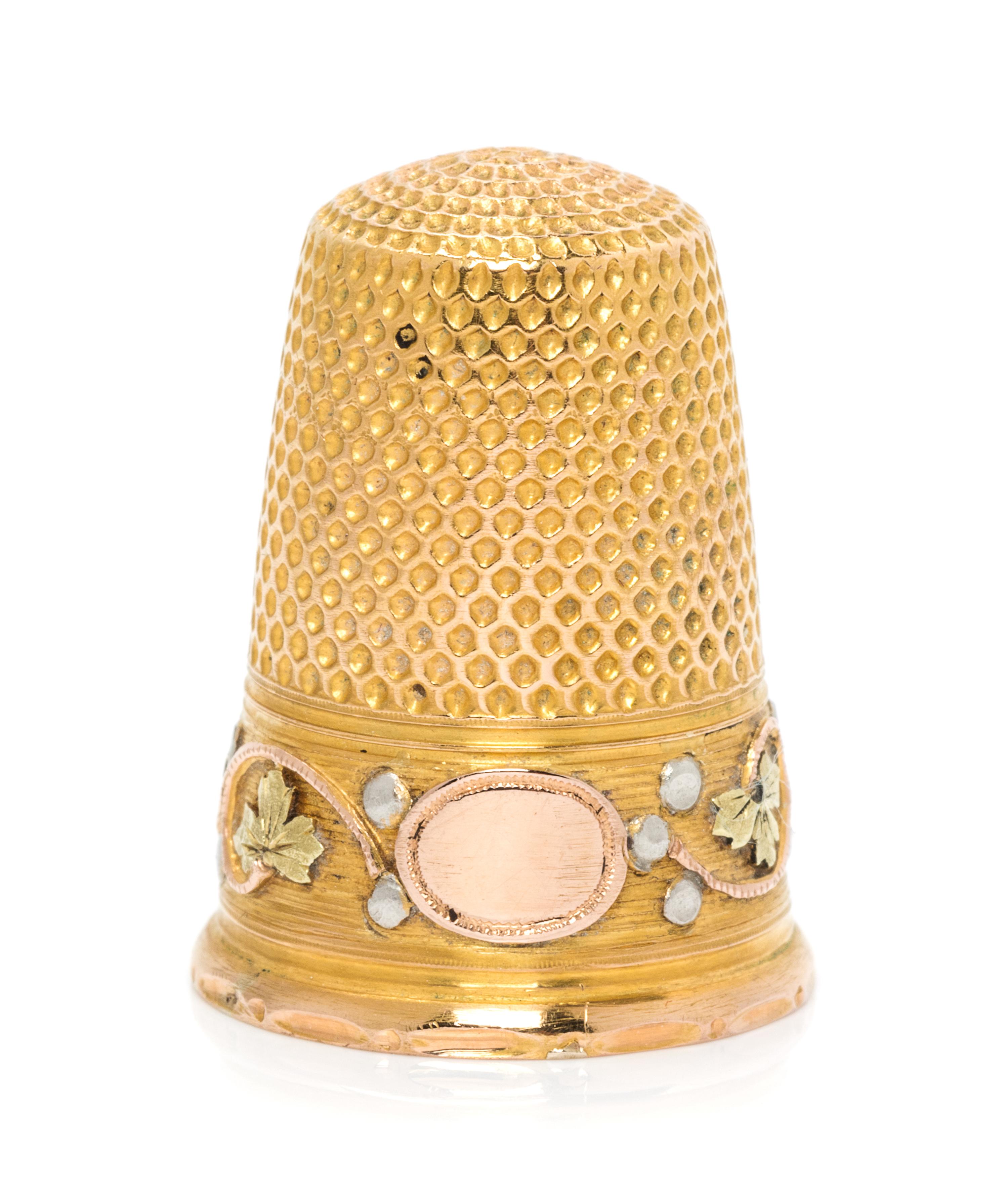 A French Tri-Colored Gold Thimble, , the knurled top and body above a rose, white and yellow gold band worked to show foliate and berry