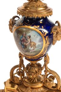 A Louis XVI Style Gilt Bronze and Sèvres Style Porcelain Clock Garniture