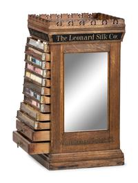 A Leonard Silk Co. Oak Floor Spool Cabinet