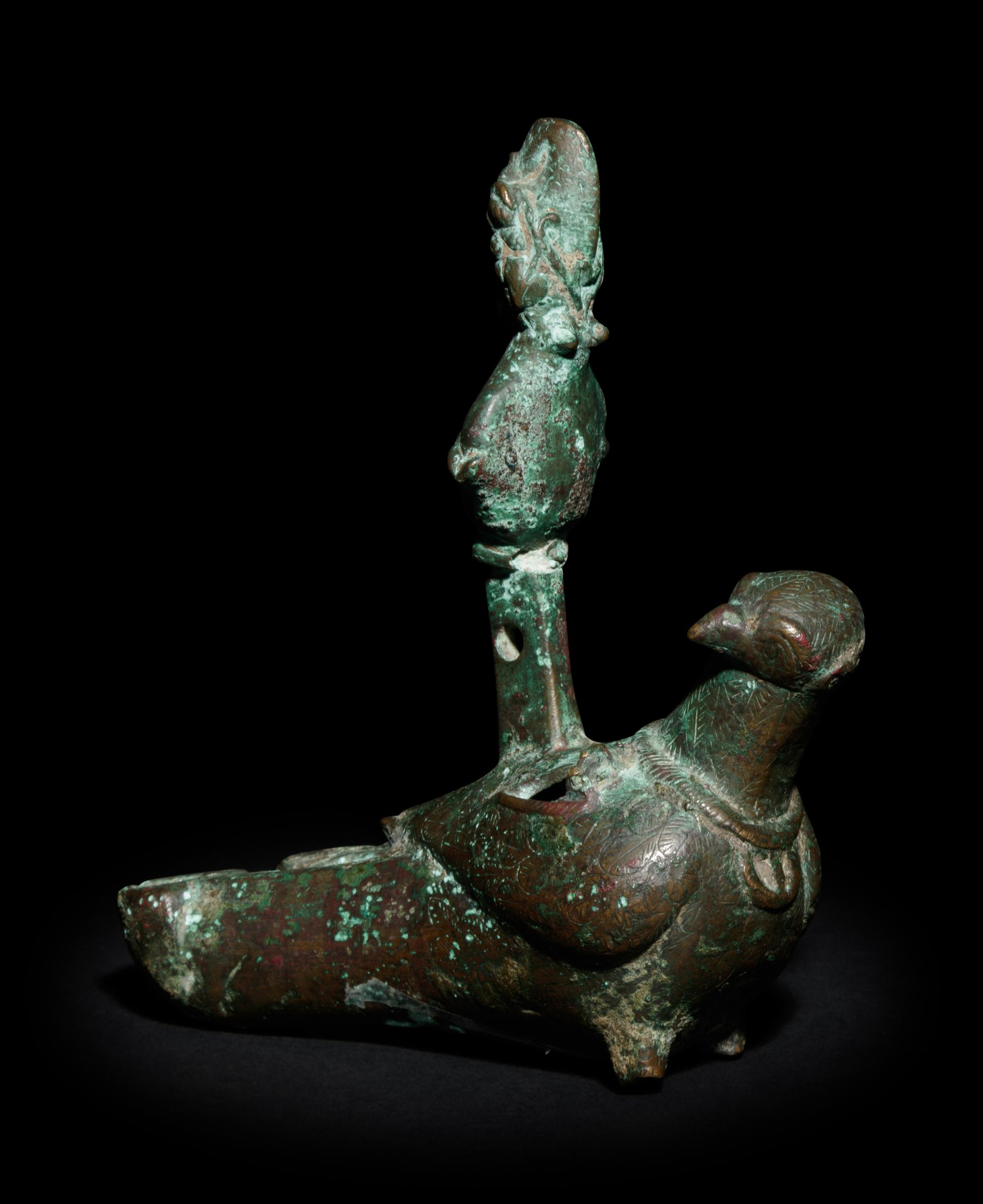 A Roman Bronze Oil Lamp in the Shape of a Dove with the Bust of a Goddess
