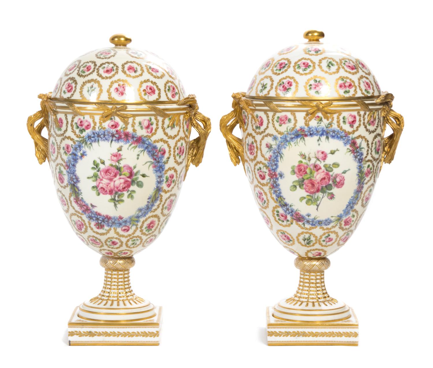A Pair of Continental Porcelain Urns and Covers Height 16 1/2 inches.