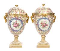 A Pair of Continental Porcelain Urns and Covers Height 16 1/2 inches.