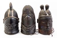A Group of Three Helmet Masks Height of tallest 15 1/4 inches.