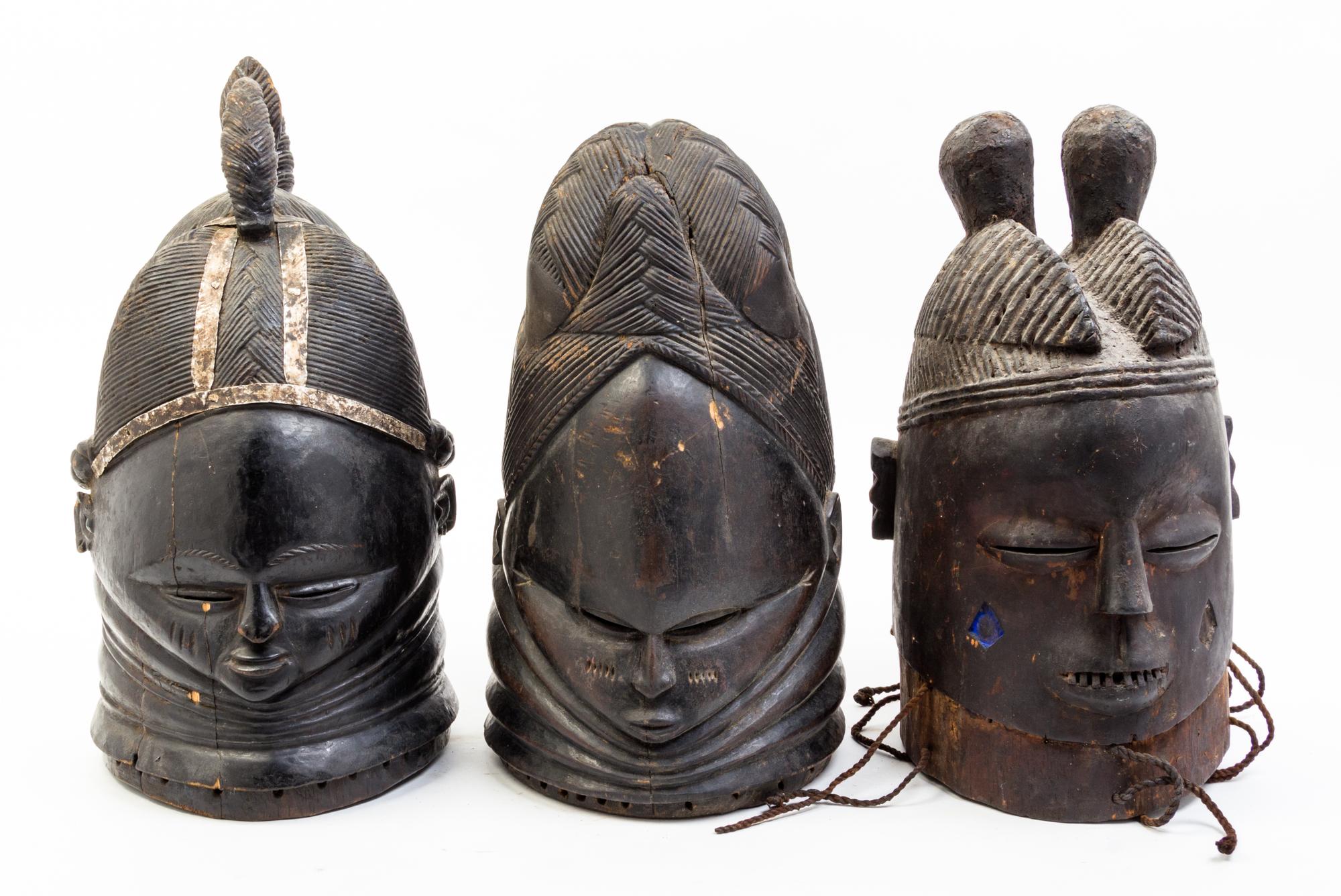 A Group of Three Helmet Masks Height of tallest 15 1/4 inches.