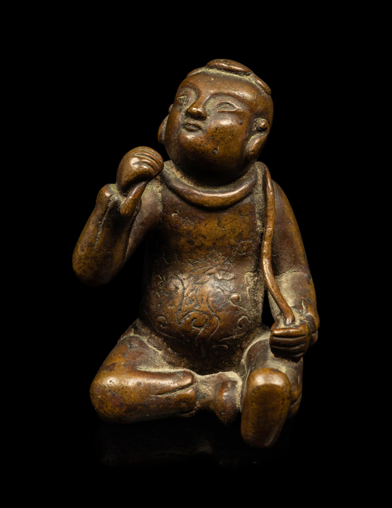 A Small Chinese Bronze Figure of a Seated Boy