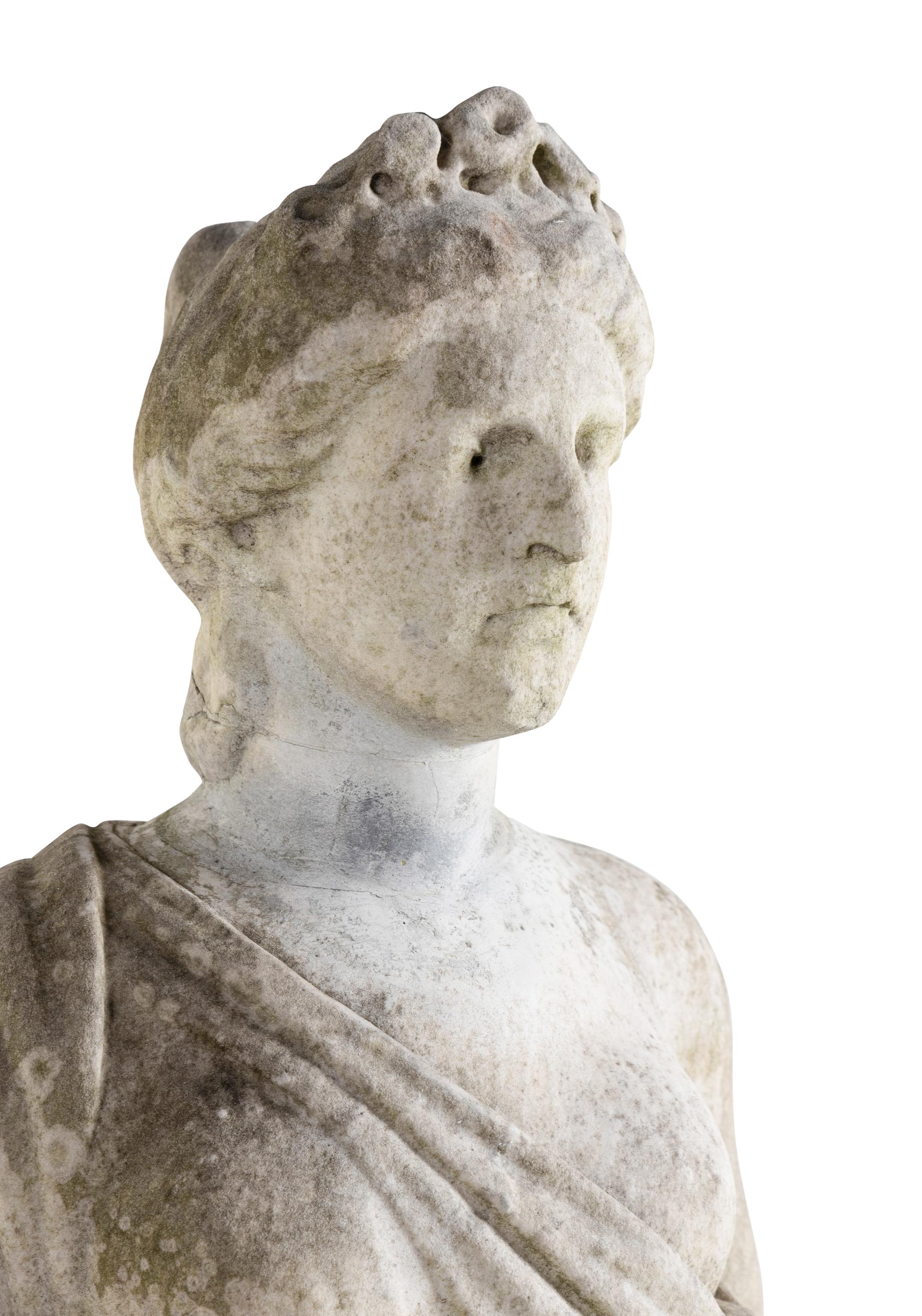 A Carved Marble Figure of a Maiden with Garlands