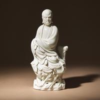 A Chinese Blanc-de-Chine Porcelain Seated Figure of Damo with 'He Chaozong' Mark, Qing Dynasty — 清 何朝宗款“隻履西歸”德化白瓷達摩坐像