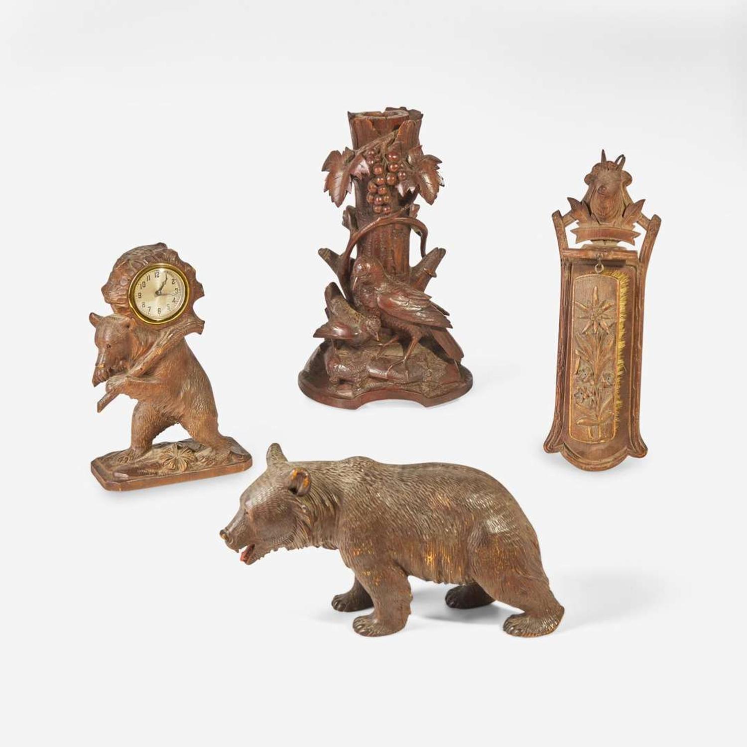A group of four Black Forest carved walnut items Swiss or German, late 19th / 20th century
