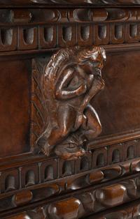 An Italian Renaissance Revival Carved Walnut Chest of Drawers