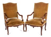 A Pair of Victorian Carved Walnut Open Armchairs Height 44 1/4 inches.