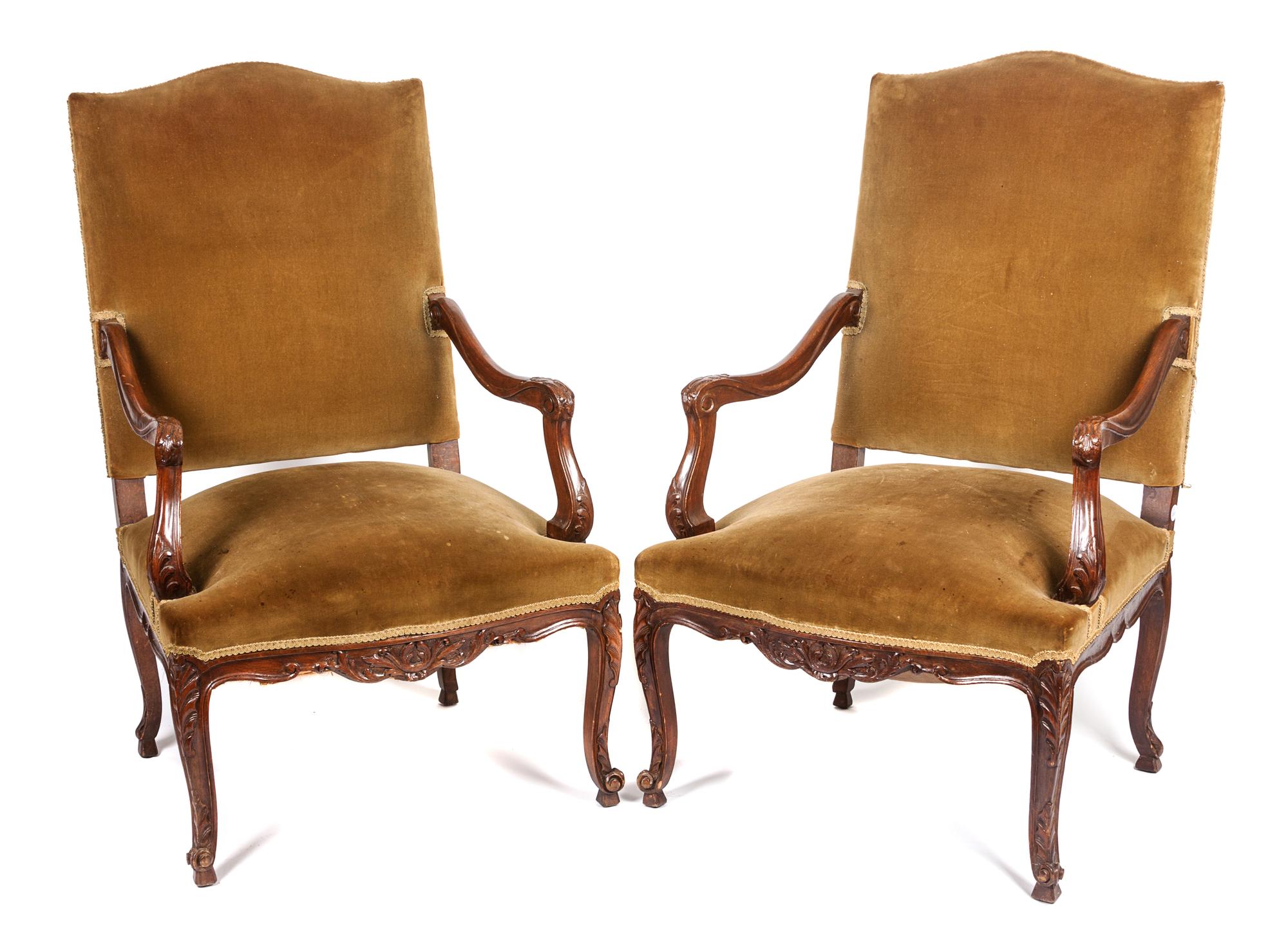 A Pair of Victorian Carved Walnut Open Armchairs Height 44 1/4 inches.