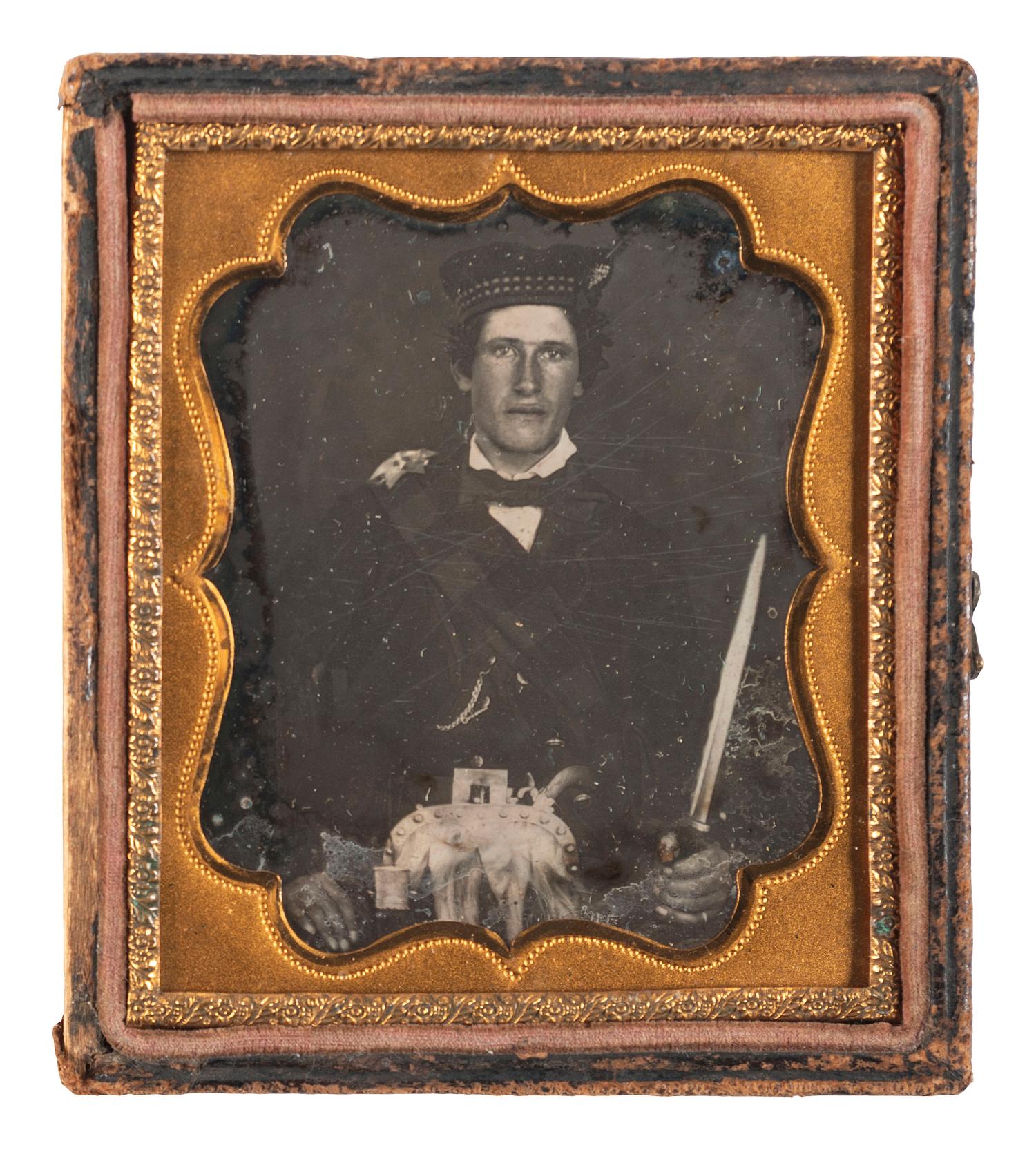 [EARLY PHOTOGRAPHY]. A sixth plate daguerreotype portrait of a possible Highland soldier armed with a Scottish dirk. Ca mid-1850s.
