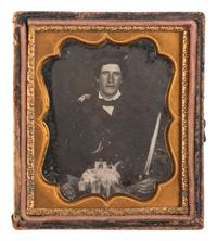 [EARLY PHOTOGRAPHY]. A sixth plate daguerreotype portrait of a possible Highland soldier armed with a Scottish dirk. Ca mid-1850s.