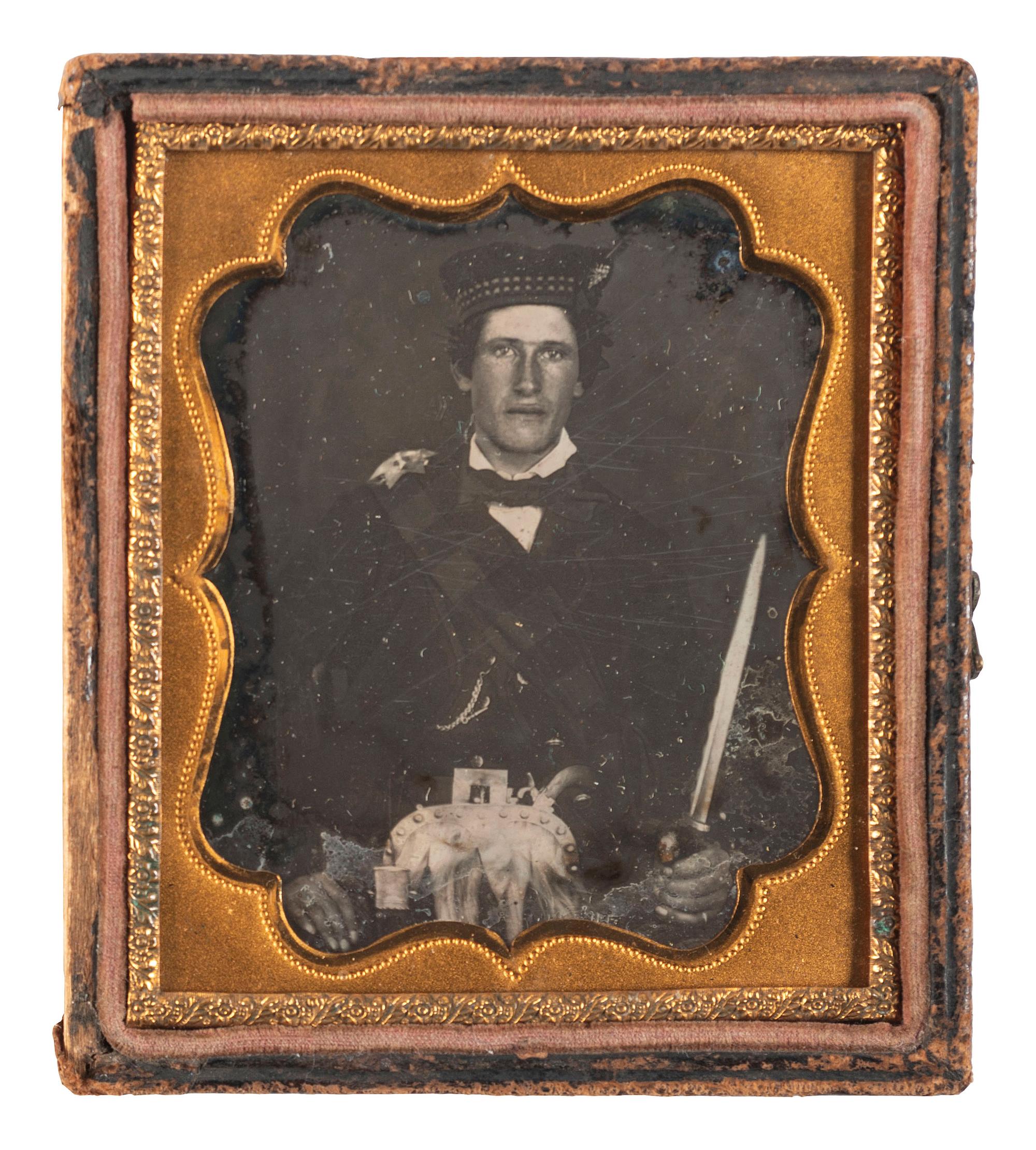 [EARLY PHOTOGRAPHY]. A sixth plate daguerreotype portrait of a possible Highland soldier armed with a Scottish dirk. Ca mid-1850s.