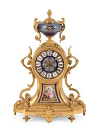 A Louis XVI Style Porcelain Inset Gilt Bronze Mantel Clock