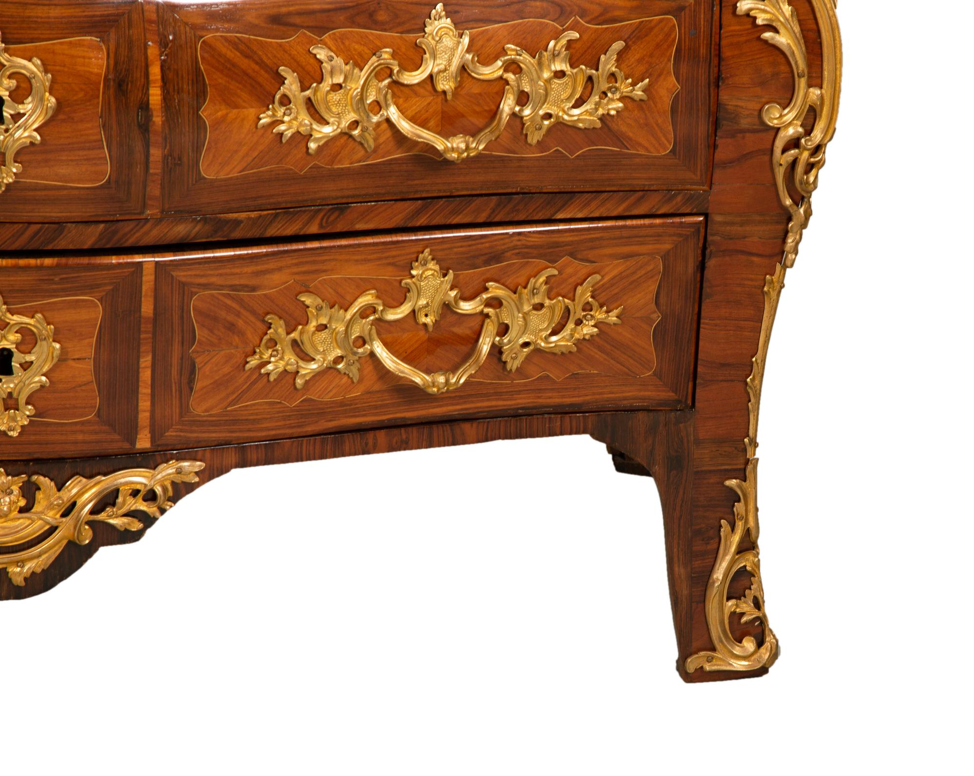 A Louis XV Gilt Bronze Mounted Kingwood and Tulipwood Marble Top Bombé Commode