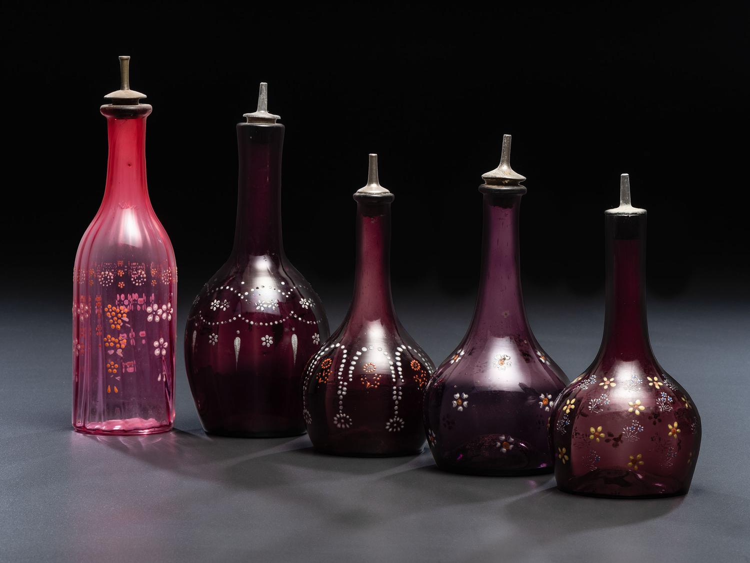 Five Enameled Glass Barber Bottles