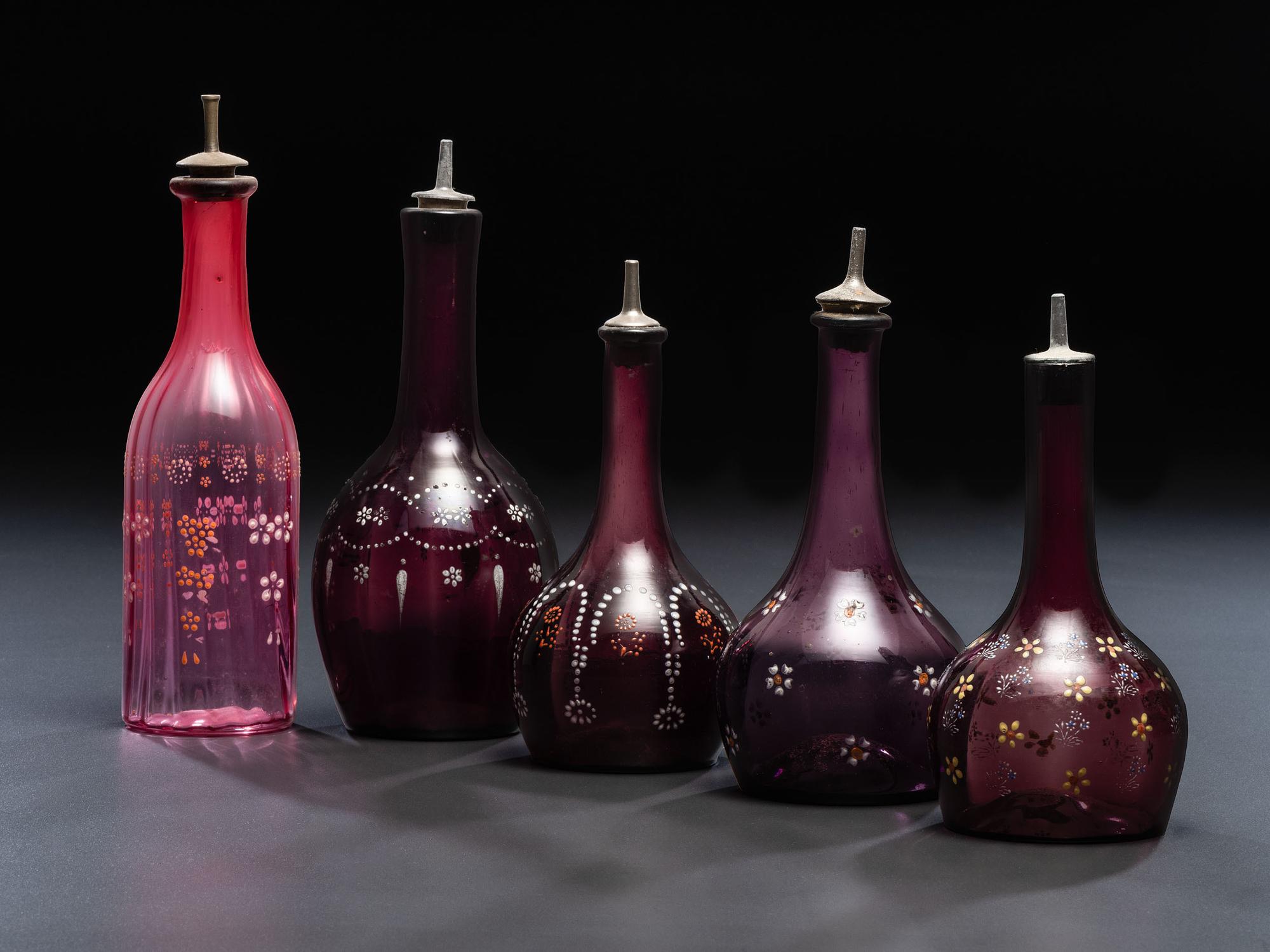 Five Enameled Glass Barber Bottles