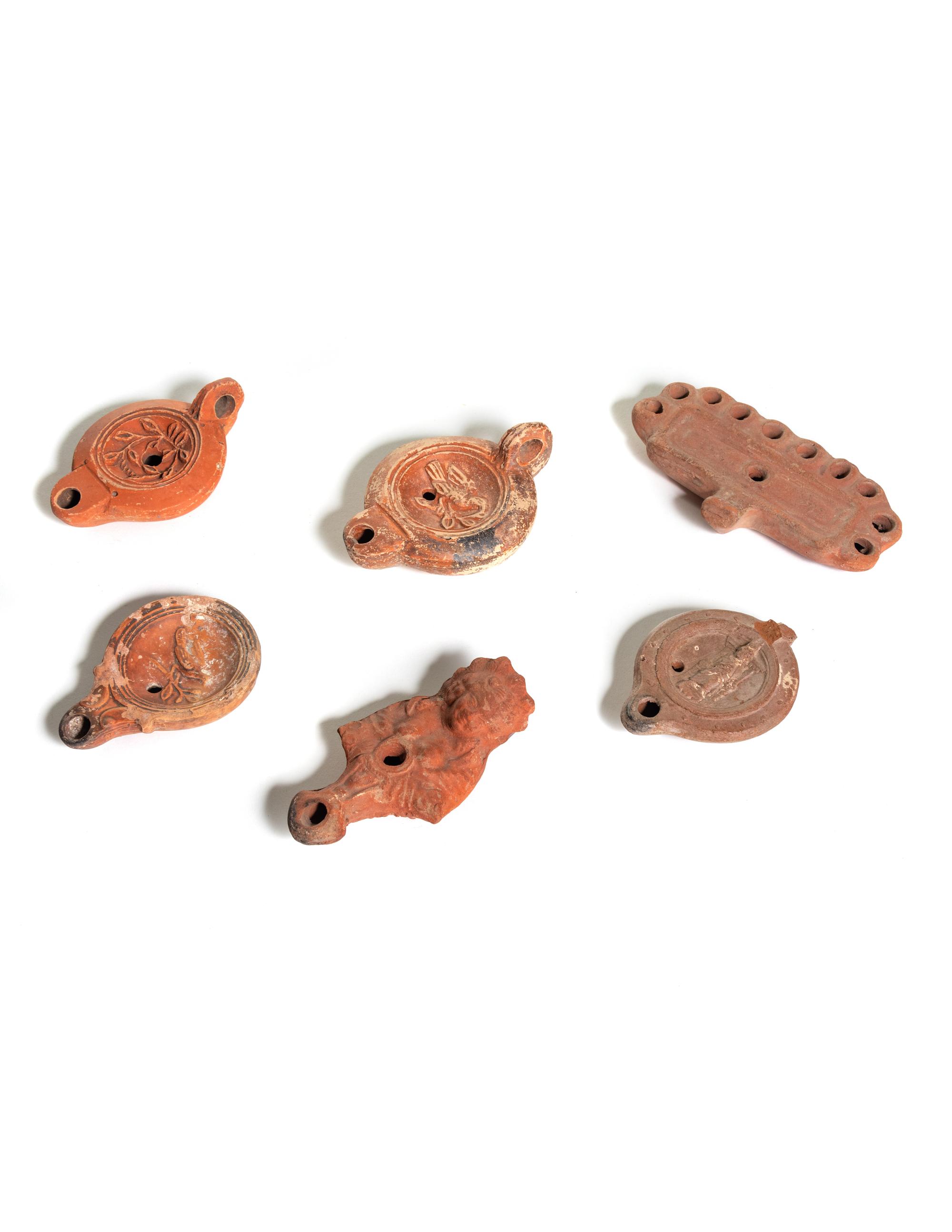 Six Roman Molded Terra Cotta Oil Lamps