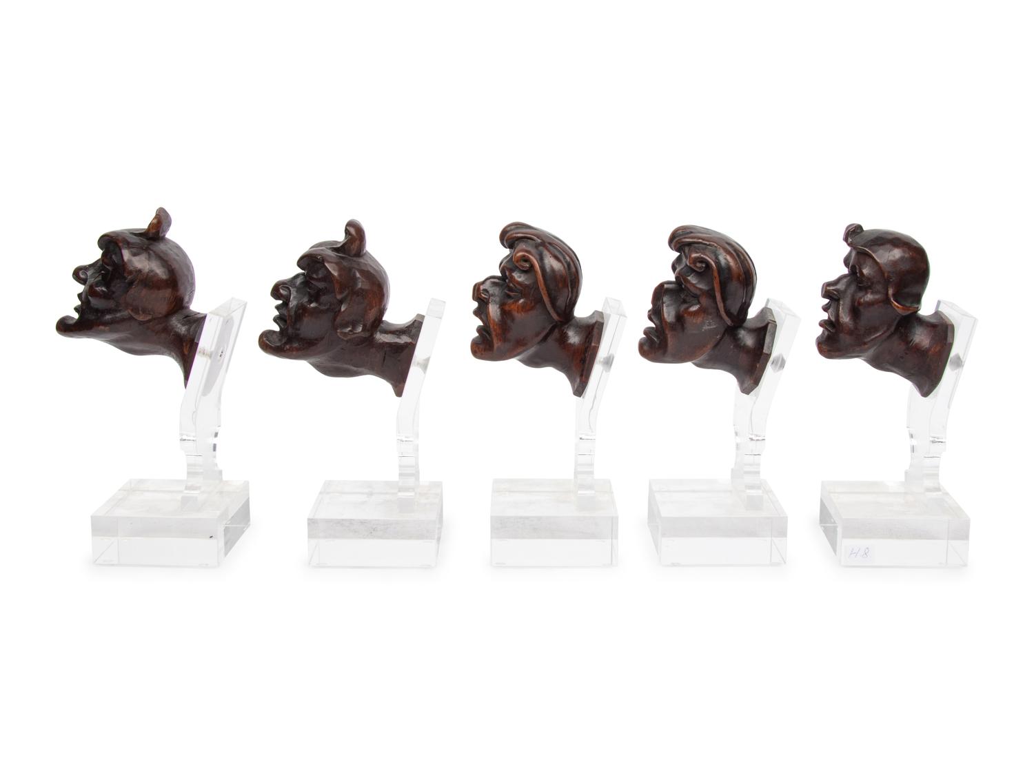 A Set of Five Italian Baroque Carved Walnut Heads of Grotesques