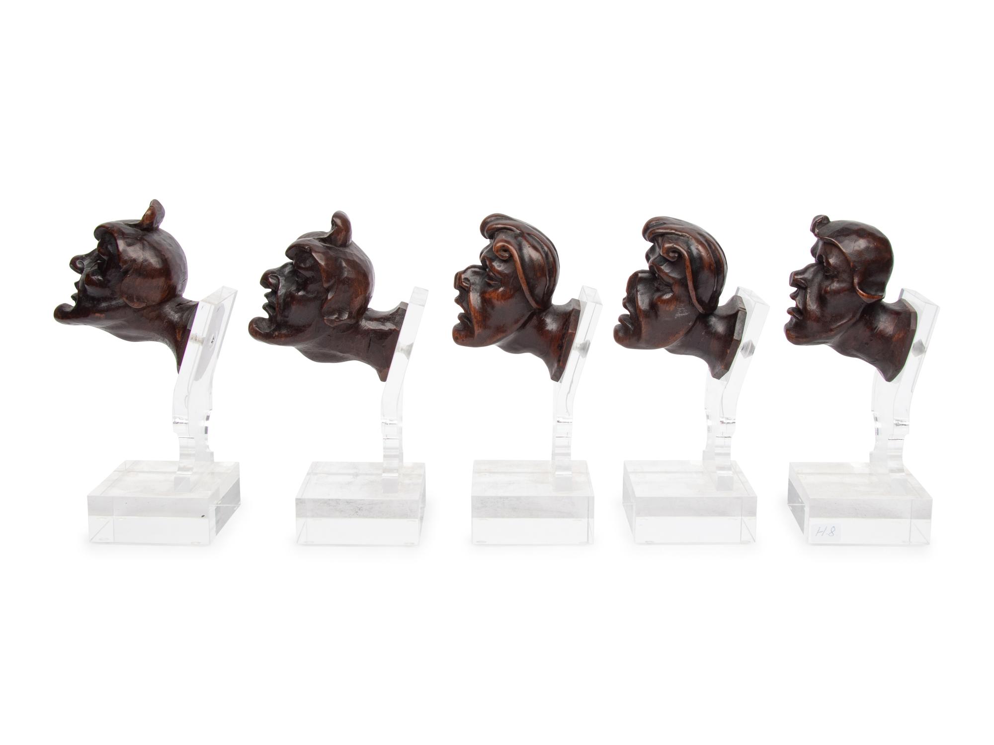 A Set of Five Italian Baroque Carved Walnut Heads of Grotesques