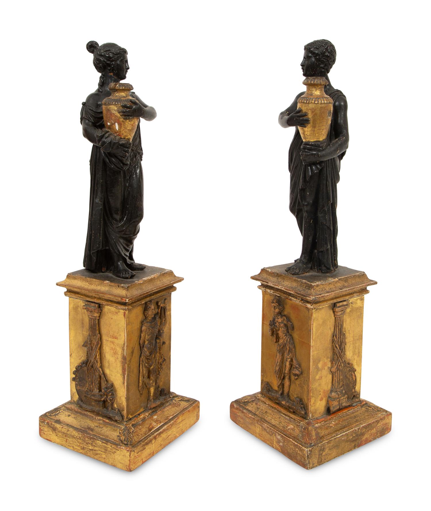 A Pair of Continental Carved, Parcel Ebonized and Gilt Wood Neoclassical Figures