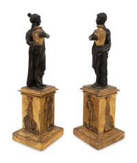 A Pair of Continental Carved, Parcel Ebonized and Gilt Wood Neoclassical Figures