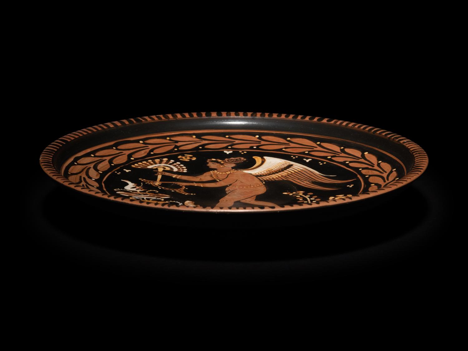 An Apulian Red-Figured Plate with Striding Eros