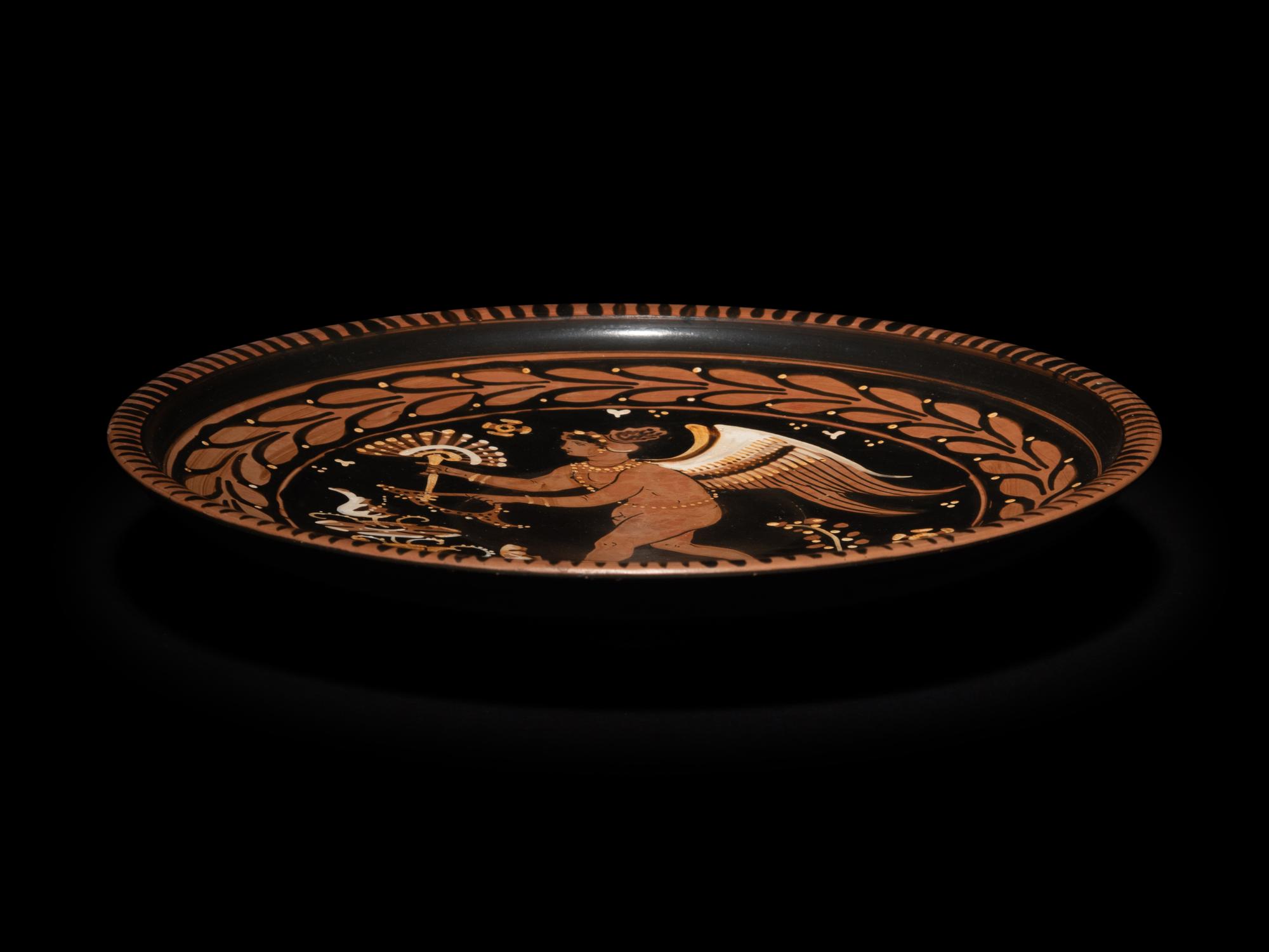 An Apulian Red-Figured Plate with Striding Eros
