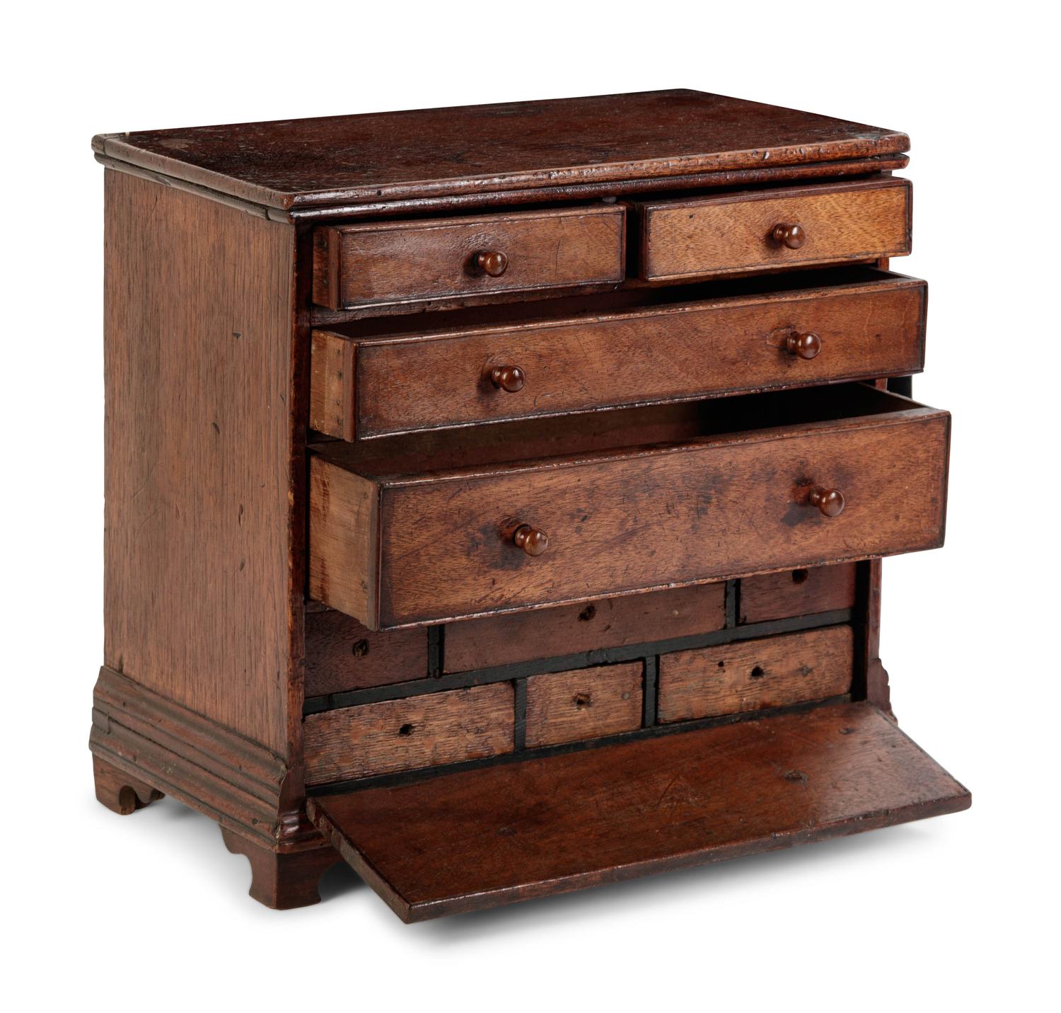 A Diminutive Walnut Chest of Drawers