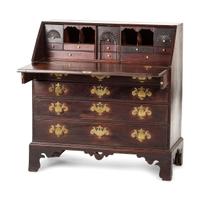 A Chippendale Carved and Figured Mahogany Slant-Front Desk