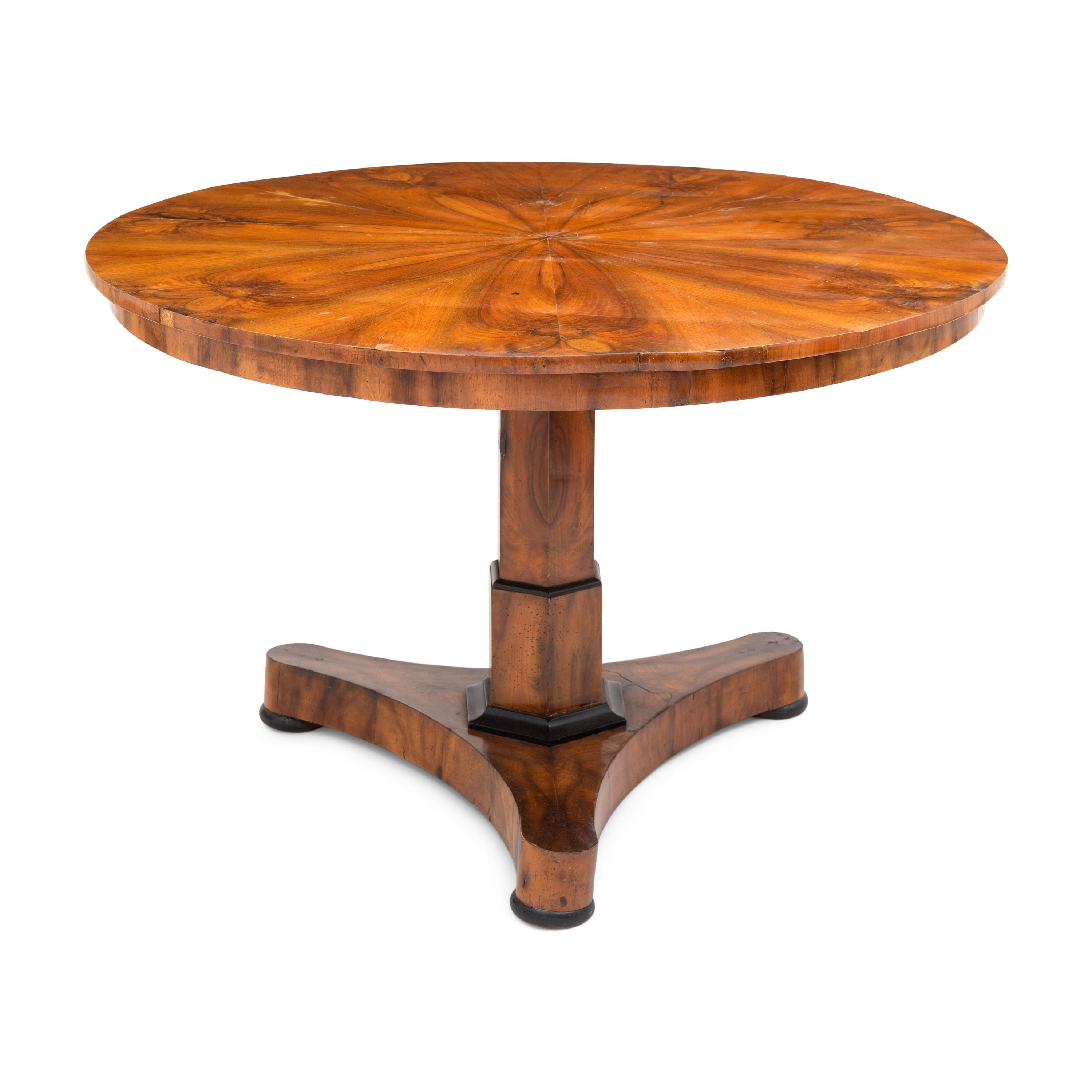 A Biedermeier Figured Walnut and Ebonized Center Table
