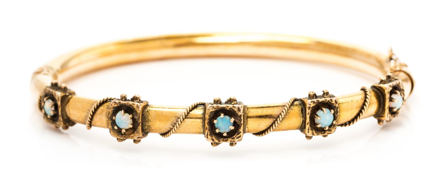 A 14 Yellow Gold and Opal Bangle Bracelet, 10.20 dwts.
