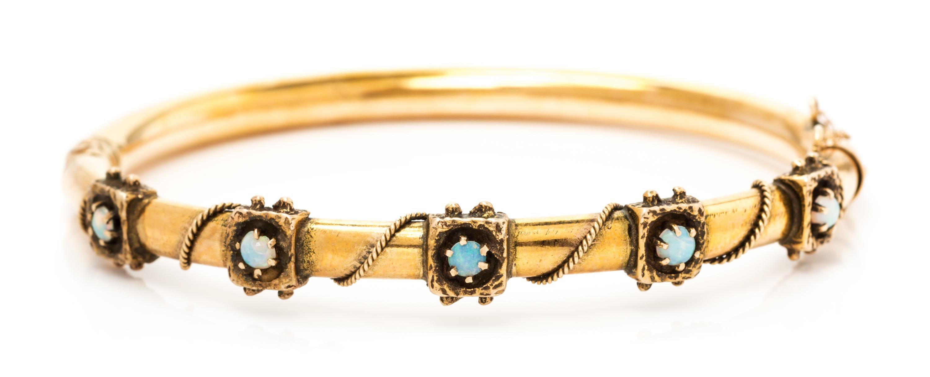 A 14 Yellow Gold and Opal Bangle Bracelet, 10.20 dwts.