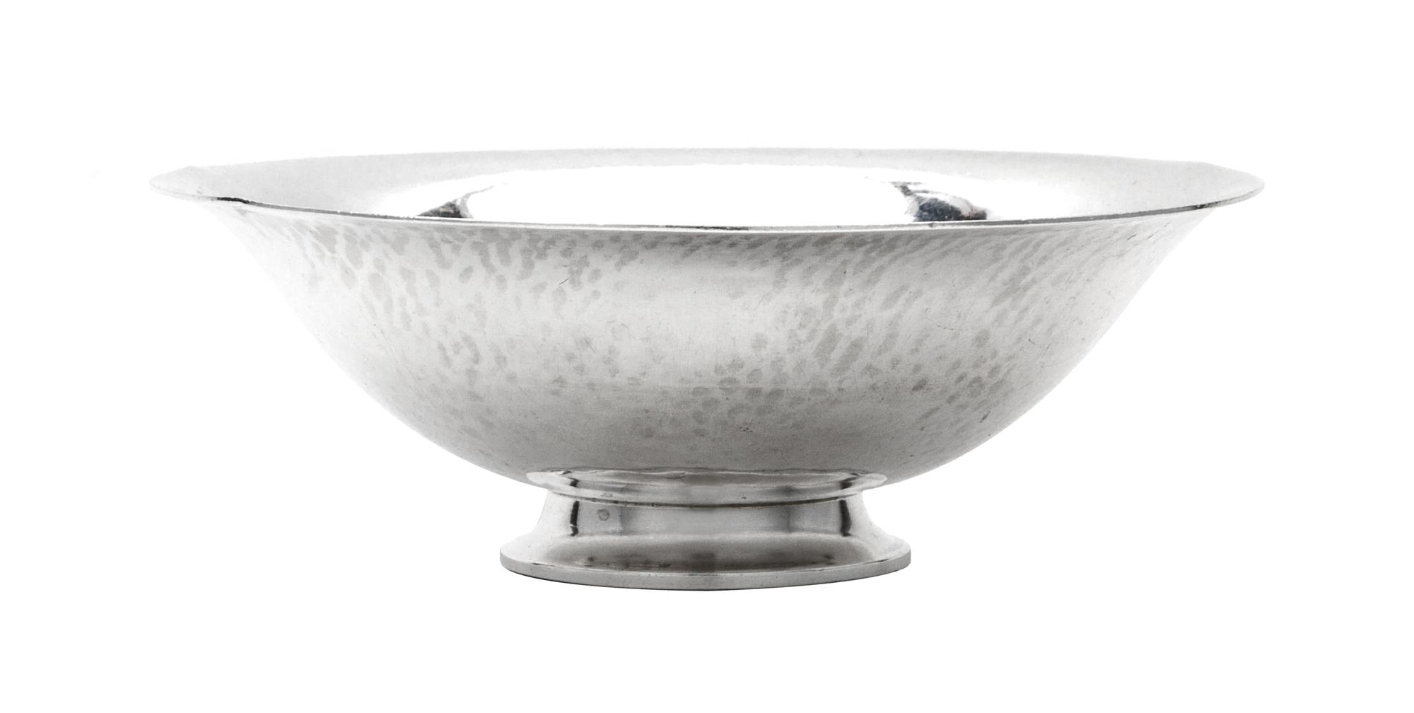 A Danish Silver Bowl, Georg Jensen Silversmithy, Copenhagen, 1933-1944, having a spot hammered finish and raised on a stepped foot.