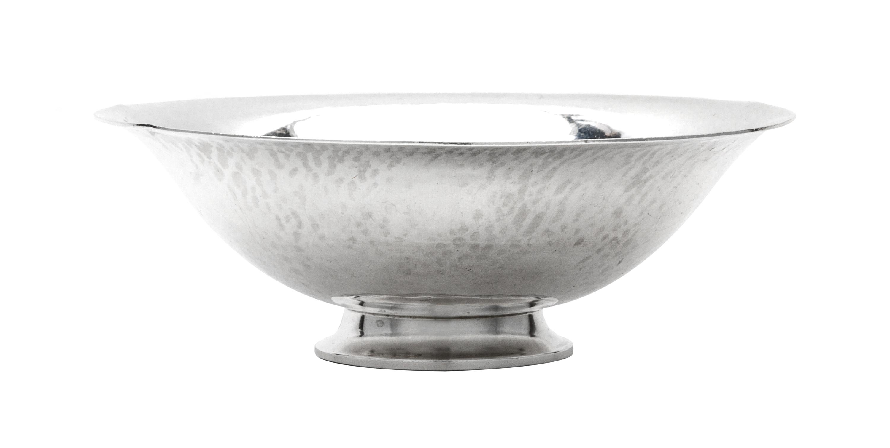 A Danish Silver Bowl, Georg Jensen Silversmithy, Copenhagen, 1933-1944, having a spot hammered finish and raised on a stepped foot.
