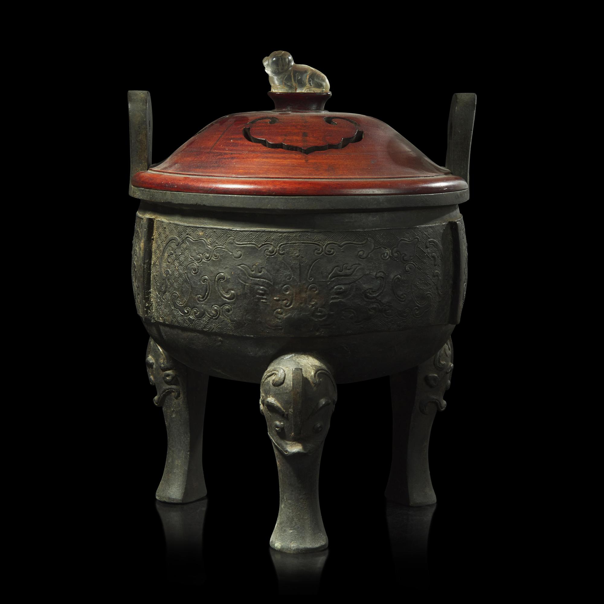 A large Chinese patinated bronze archaistic tripod censer, Ding, and wood cover, The Bronze 17th/18th Century or Earlier 清 青銅鼎式爐