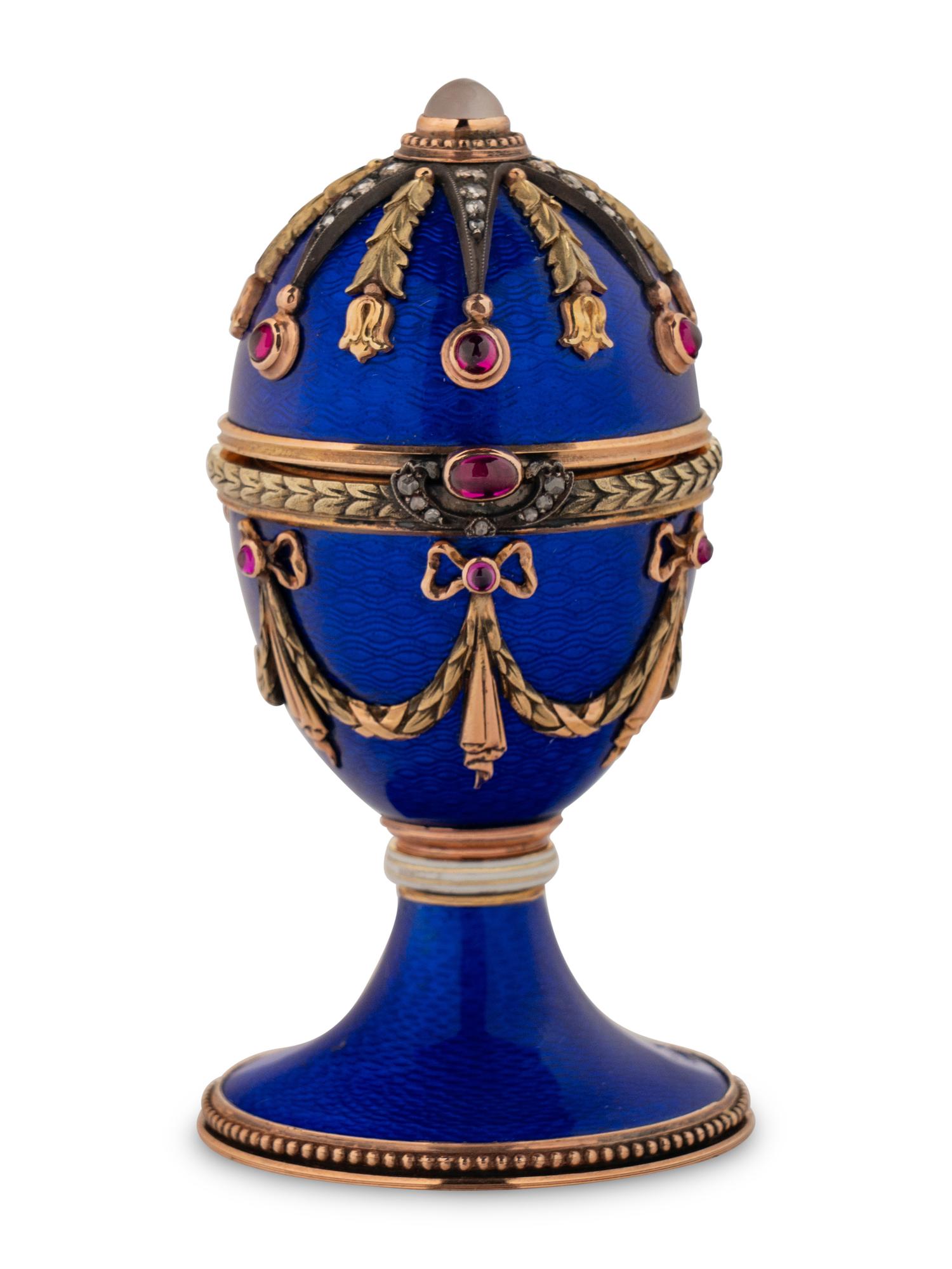A 14 Karat Vari-Color Gold, Guilloché Enamel, Diamond, and Cabochon Jewel-Mounted Egg-Form Perfume and a Related Guilloché Enamel, 14 Karat Vari-Color Gold, Diamond, and Cabochon-Mounted Surprise Egg