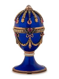 A 14 Karat Vari-Color Gold, Guilloché Enamel, Diamond, and Cabochon Jewel-Mounted Egg-Form Perfume and a Related Guilloché Enamel, 14 Karat Vari-Color Gold, Diamond, and Cabochon-Mounted Surprise Egg