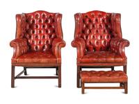 A Pair of Leather Wingback Armchairs with Ottoman